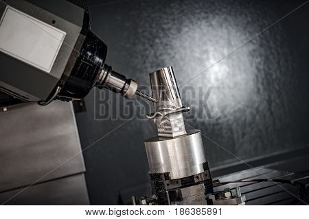 Metalworking CNC milling machine. Cutting metal modern processing technology. Small depth of field. Warning - authentic shooting in challenging conditions. A little bit grain and maybe blurred.