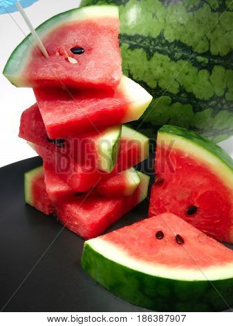 Freshly Chopped Red Summer Watermelon on a Black Dish