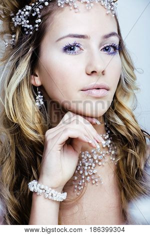 beauty young snow queen with hair crown on her head, complicate hairstyle, winter concept close up
