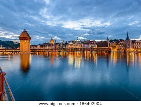 Night view towards Chapel Bridge (Kapellbruecke) together with the octagonal tall tower (Wasserturm) it is one of the Lucerne's most famous tourists attraction
