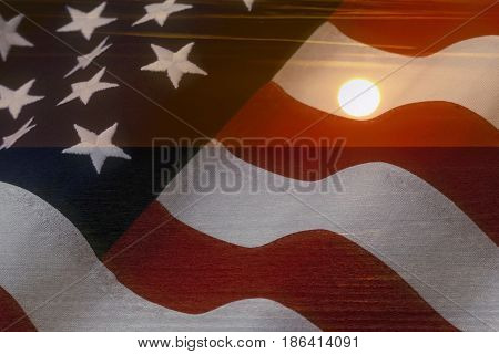 American flag and bright sunshine on ocean - USA patriotic concept