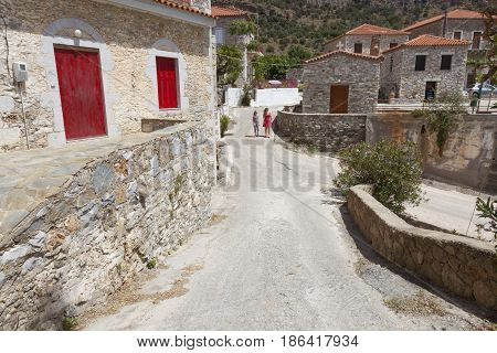 agios dimitrios greece, 28 april 2017: tourists walk in village of agios dimitrios on the coast of messenia in mani part of peloponnese on sunny day in spring