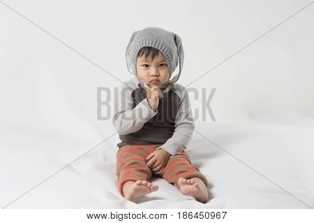 Asian cute little baby in bunny hat  on white background.