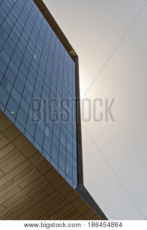 Corner detail of a modern building facade on a bright sunny day with clear sky. Abstract background. Space for text