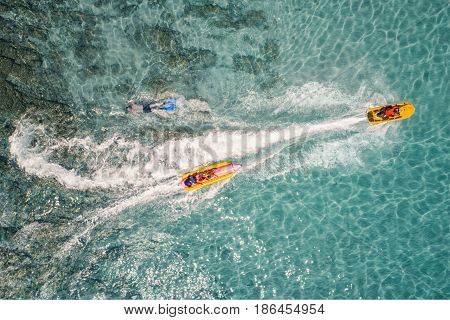 Top view of Banana boat playing and diving in Koh Larn Pataya city Chonburi.