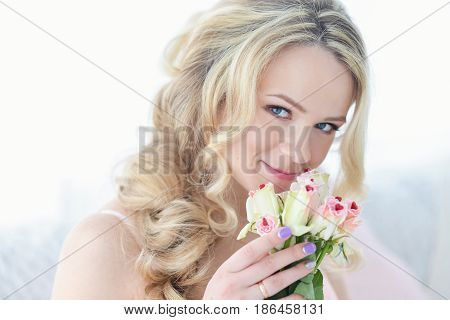 Young happy smiling cheerful woman with bouquet of white roses