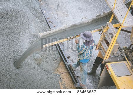 construction worker pouring concrete from cement truck vintage photo