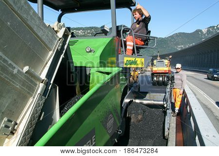 Workers And Vehicles During The Asphalting Of The Highway