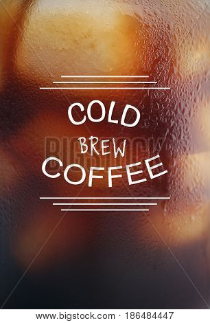Text COLD BREW COFFEE on steamed glass background