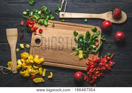 copy space cutting Board with ingredients pepper tomato