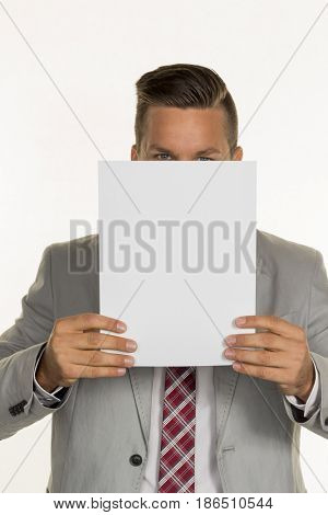 manager holding blank sheet in front of face