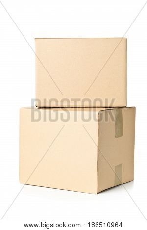 Two corrugated cardboard carton parcels stacked on white background