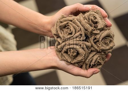 Bouquet of artificial beautiful grey roses made of burlap