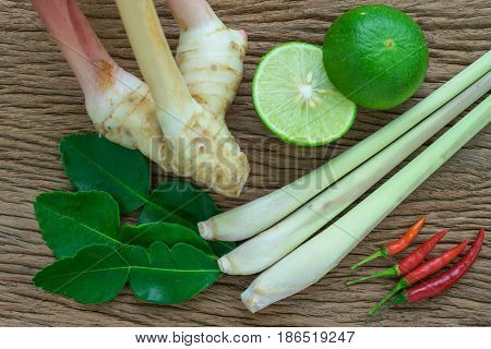 Tom yam ingredient lemon lemongrass galangal and chili on wood table for thai spicy soup.