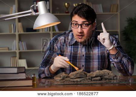 Archeologist working late night in office