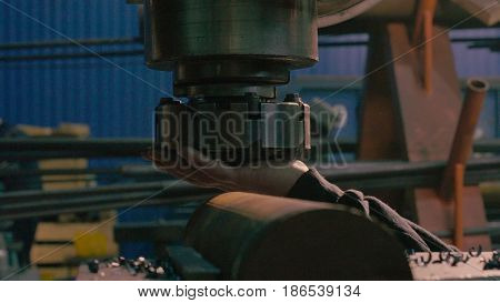 Close up of men's hands screwing the milling cutter on the milling machine