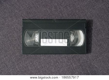 One video cassette from the front side on a gray background