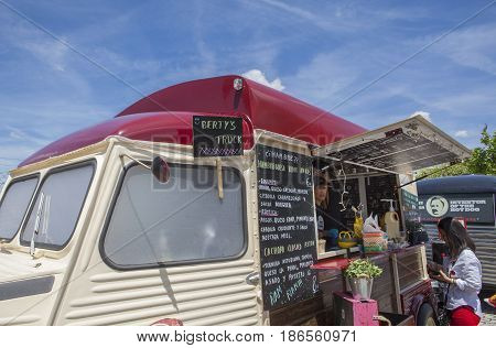 Merida Spain - May 14 2017: People around a local festival with different food trucks in the historical city of Merida Extremadura Spain