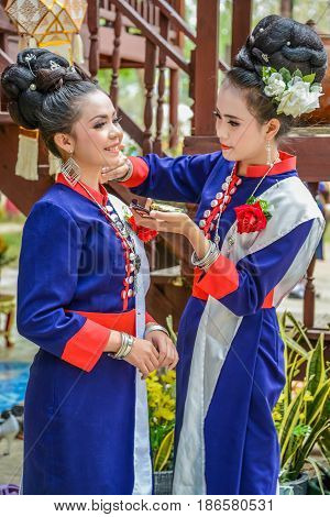 NAKORN PHANOM THAILAND - FEBRUARY 14 2015: Thai northeastern Phutai dancers with traditional costume in Phutai world event day in Renunakorn of Nakorn Phanom Thailand.