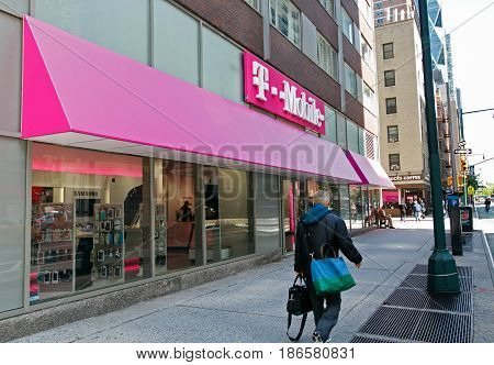 New York May 08 2017: People walk by a T-Mobile retail store in Manhattan.