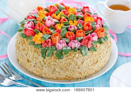 Delicious cake decorated with colorful cream flowers tulips