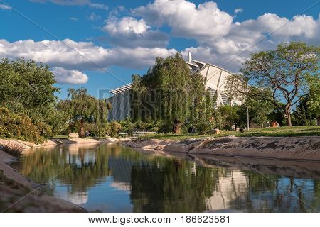 Valencia, Spain Gardens in the old dry riverbed of the Turia river, water reflection. Beautiful landscape leisure and sport area with trees, grass and water mirror