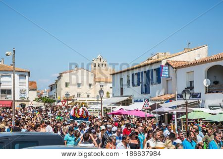Saintes-Maries-de-la-Mer, France - May 25, 2015. Religious feast in honor of the Holy Maries in Provence. The crowd is accompanied by two statues Holy Maries. The concept of ethnographic tourism