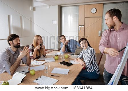 It was my topic. Group of coworkers looking at their partner leaning elbows on the table being very attentive