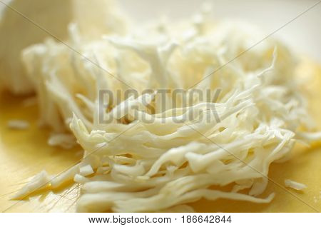 Sliced White Cabbage On A Yellow Cutting Board