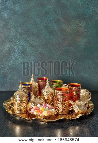 Arabic tea coffee table golden dishes. Oriental hospitality. Ramadan kareem. Eid Mubarak