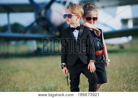 photo of young boy and girl playing spy