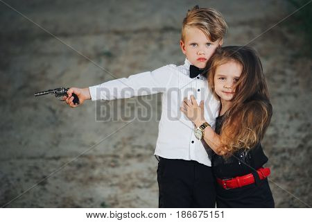 photo of young boy and girl playing spy