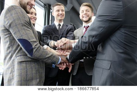 Businessman team in suit touching hands together. Selective focus