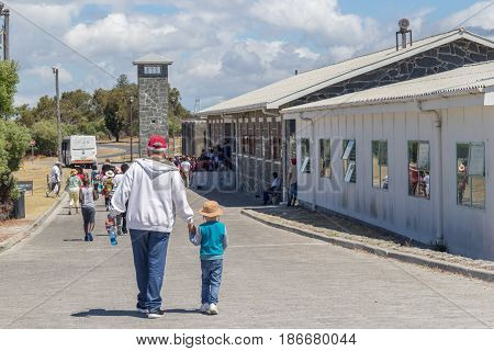 ROBBEN ISLAND SOUTH AFRICA 18 December 2016: Llittle boy and grandfather visiting the maximum security prison on Robben Island where Nelson Mandela was imprisoned - Illustrative editorial image