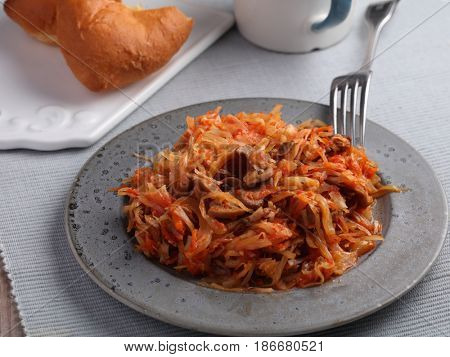 Mushroom bigos and cabbage pies on a rustic table