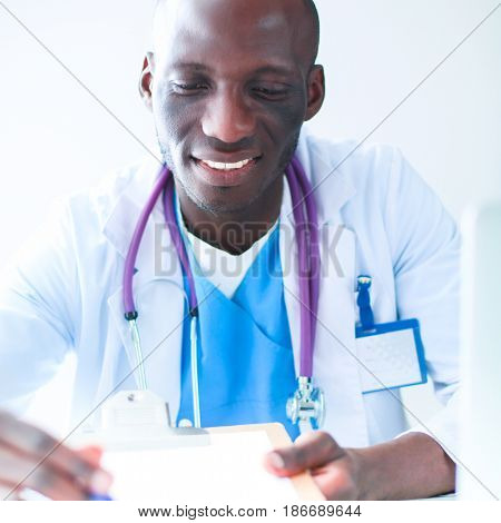 Male doctor sitting at his desk