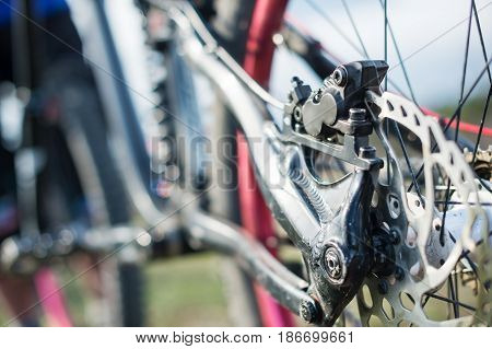 Elements of the suspension of the mtb bike of a two-pendant mountain bike close-up brake disc brake and rear suspension