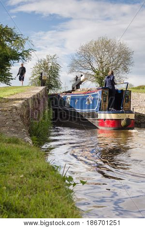 Saint Martins Shropshire UK - May 14 2017: A narrowboat entering the New Marton upper lock gate on the 200 year old Shropshire Union canal