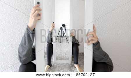 Impossible composition with mirrors and a camera with a tripod.