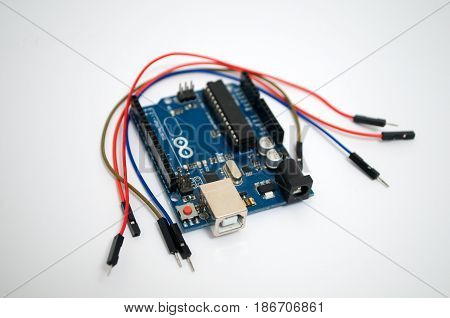 Arduino and around listed wire on a white background