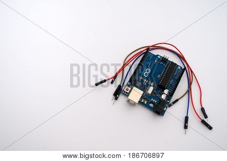 Arduino and around listed wire on a white background