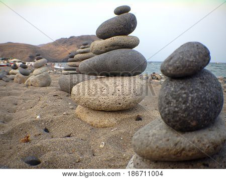 Rocks near the sea, on the sand near the beach in perfect balance.
