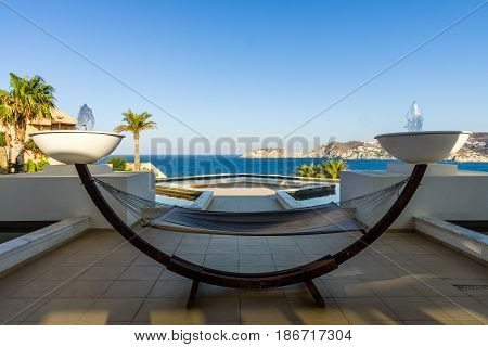 Sea view from the Mononaftis village. In the foreground a hammock for relaxing. Crete. Greece.