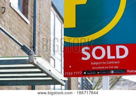 Estate Agency Sold Sign Outside A English Townhouse