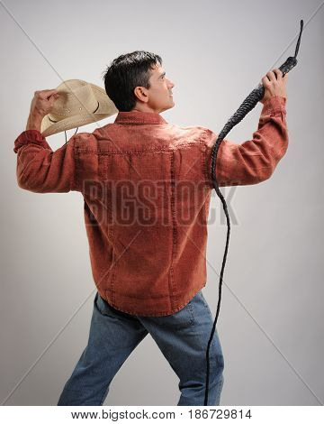 The sexy cowboy is in a unique action pose.