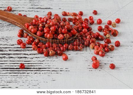 Rose pepper lay on white wooden table