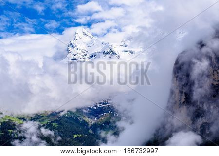 The Swiss Alps at Murren, Switzerland. Jungfrau Region. Tops of the mountains in fog and clouds.