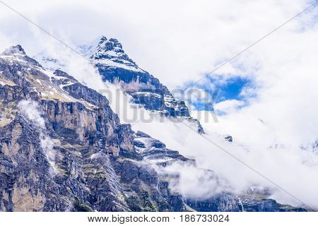 The Swiss Alps at Murren, Switzerland. Jungfrau Region. Tops of the mountains in fog and clouds.