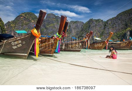 KO PHI PHI LEH, THAILAND, February 1, 2014: Traditional long tail boats on the beach of Maya Bay, Andaman Sea, famous tourist destination in the Ko Phi Phi achipelago