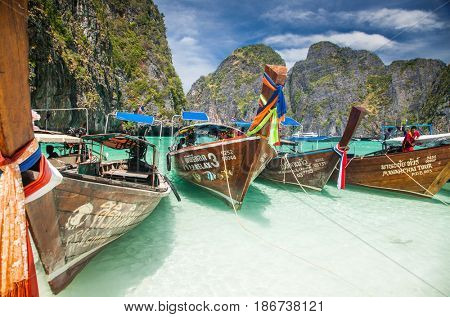 KO PHI PHI LEH, THAILAND, February 1, 2014: Traditional long tail boats on the beach of Maya Bay, Andaman Sea, famous tourist destination in the Ko Phi Phi achipelago
